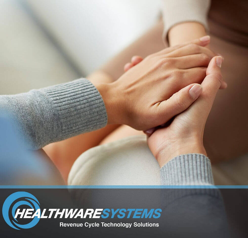 Creating a culture of patient advocacy: A healthcare employee holds a patient’s hand.